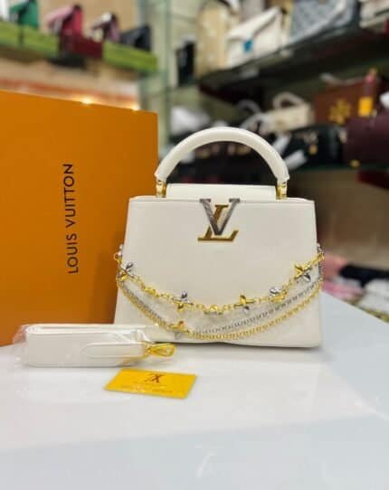 White structured top-handle bag with floral chains and matching strap